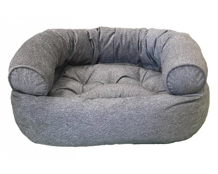 Dog resting on a plush donut-shaped dog bed from HT Animal Supply