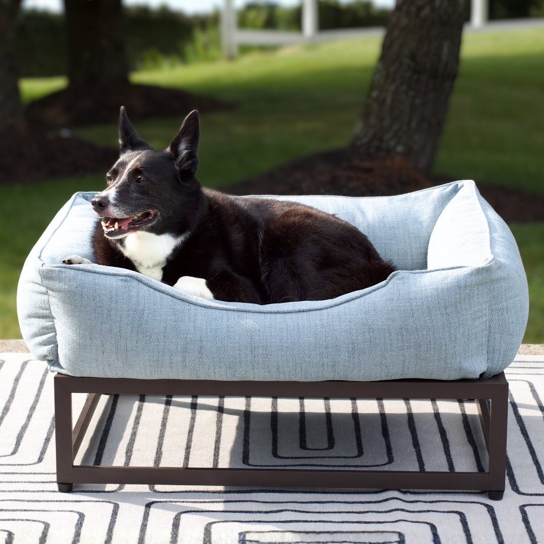 FÜZI Elevated Dog Bed in Mist Blue on brown metal base, side profile