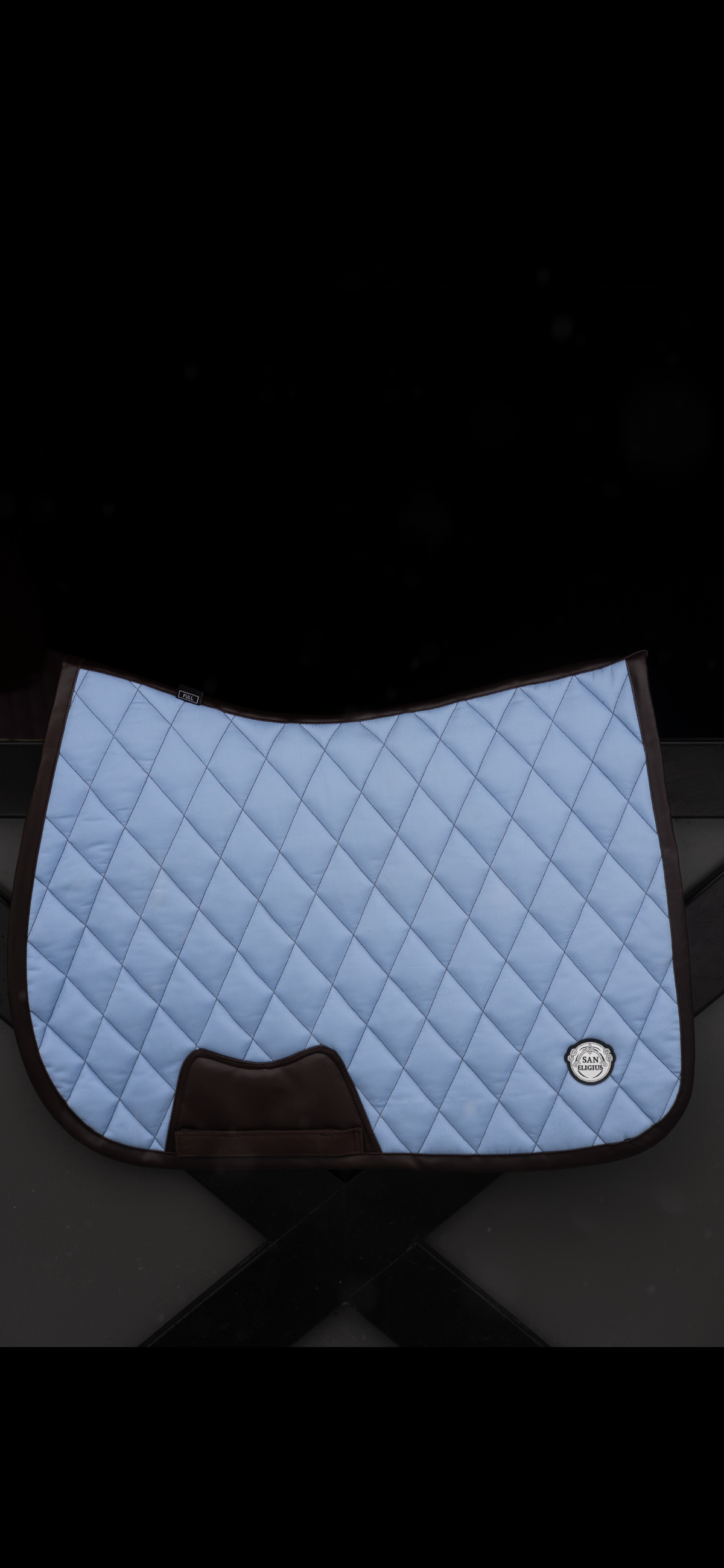 San Eligius light blue quilted jump saddle pad with brown leather piping, quilted texture detail