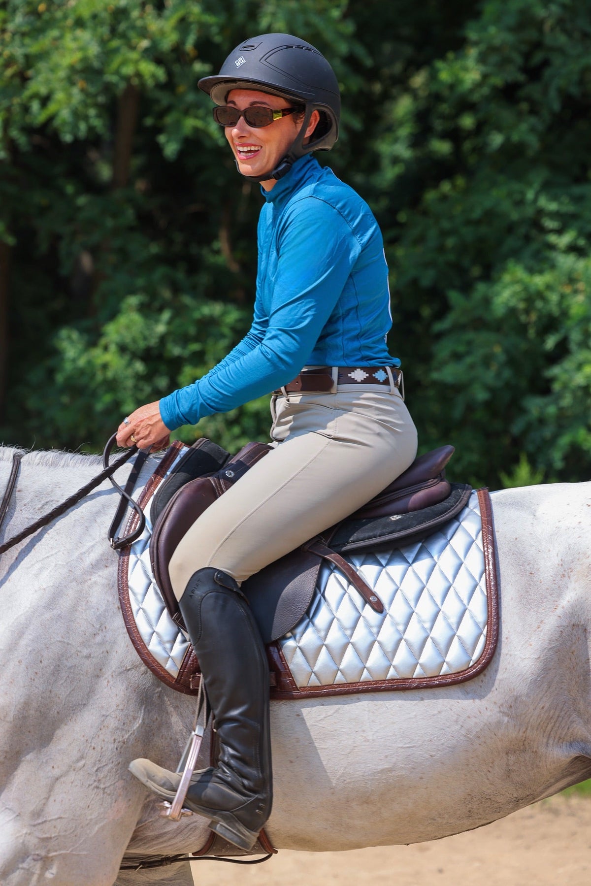San Eligius chrome quilted jump saddle pad with brown crocodile piping, angled view on horse