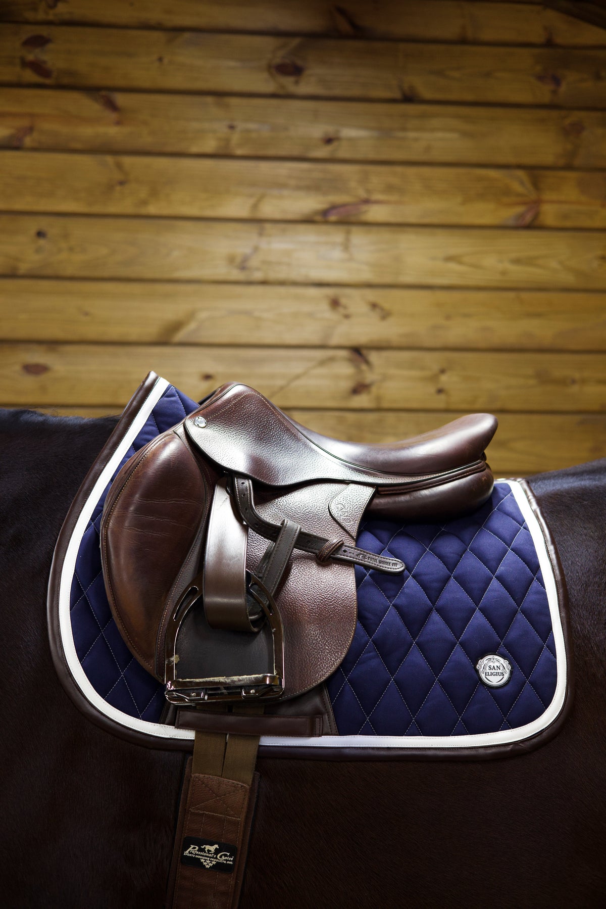 San Eligius navy quilted jump saddle pad with white and brown leather piping