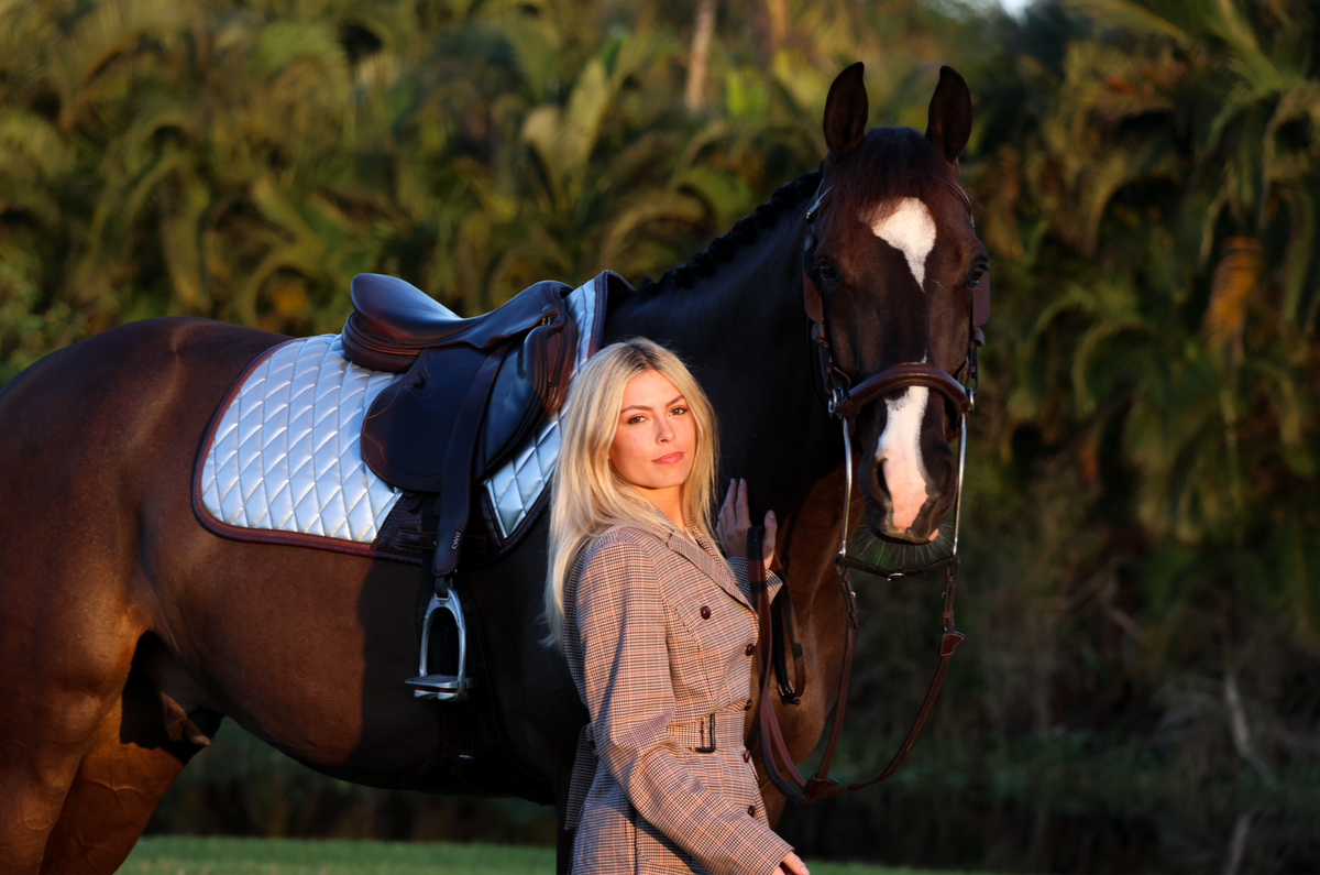 San Eligius chrome quilted jump saddle pad with brown crocodile piping, lifestyle shot on horse