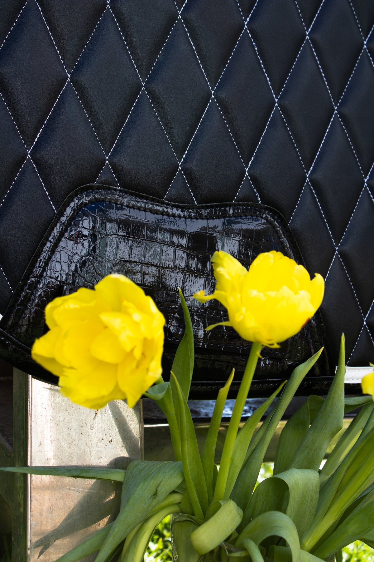 San Eligius black quilted jump saddle pad with white and black crocodile piping, girth strap detail