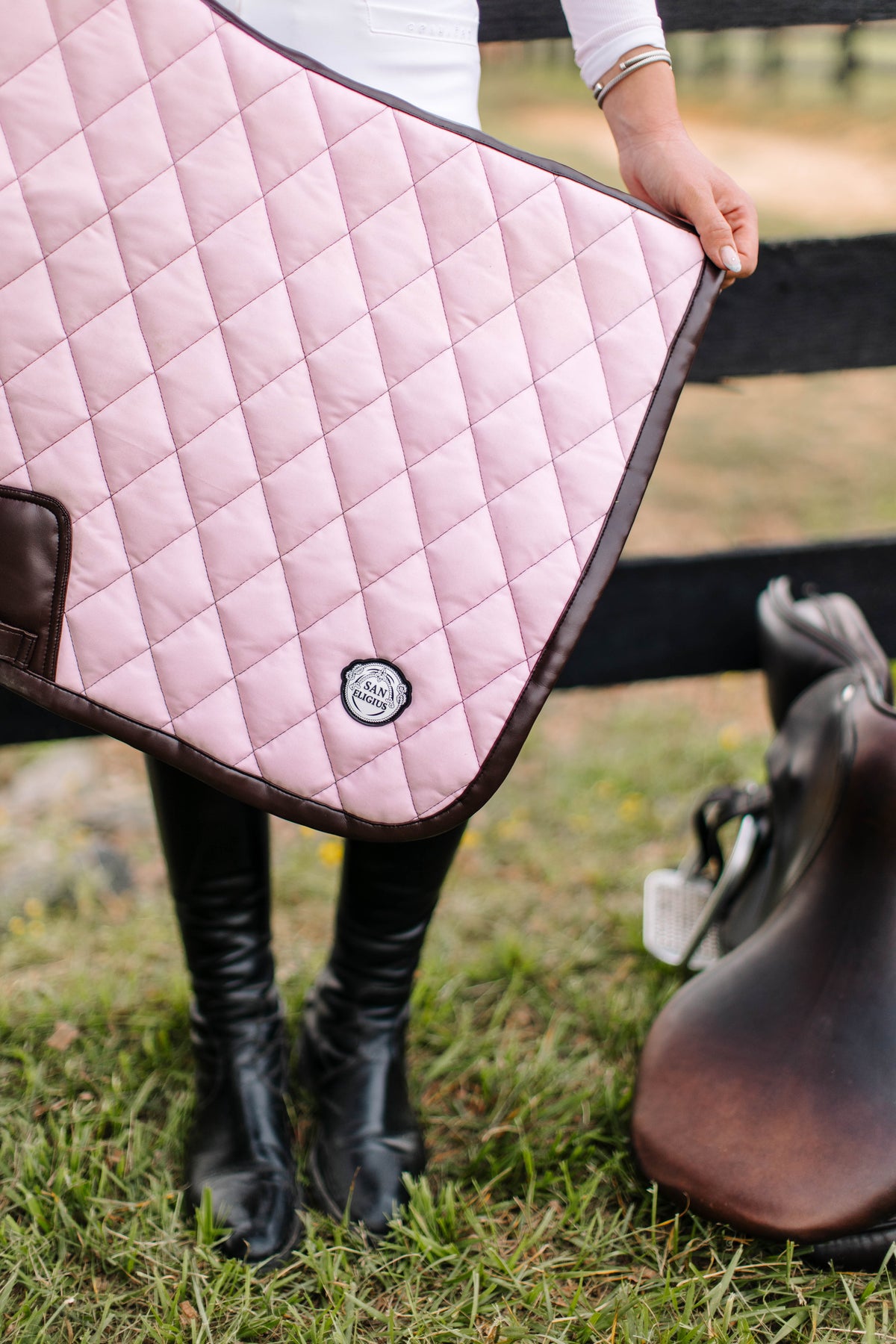 San Eligius pink quilted jump saddle pad with brown leather piping, quilted texture detail