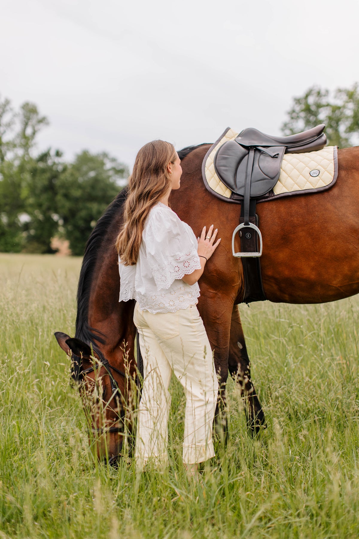 San Eligius yellow quilted jump saddle pad with brown leather piping, lifestyle shot on horse