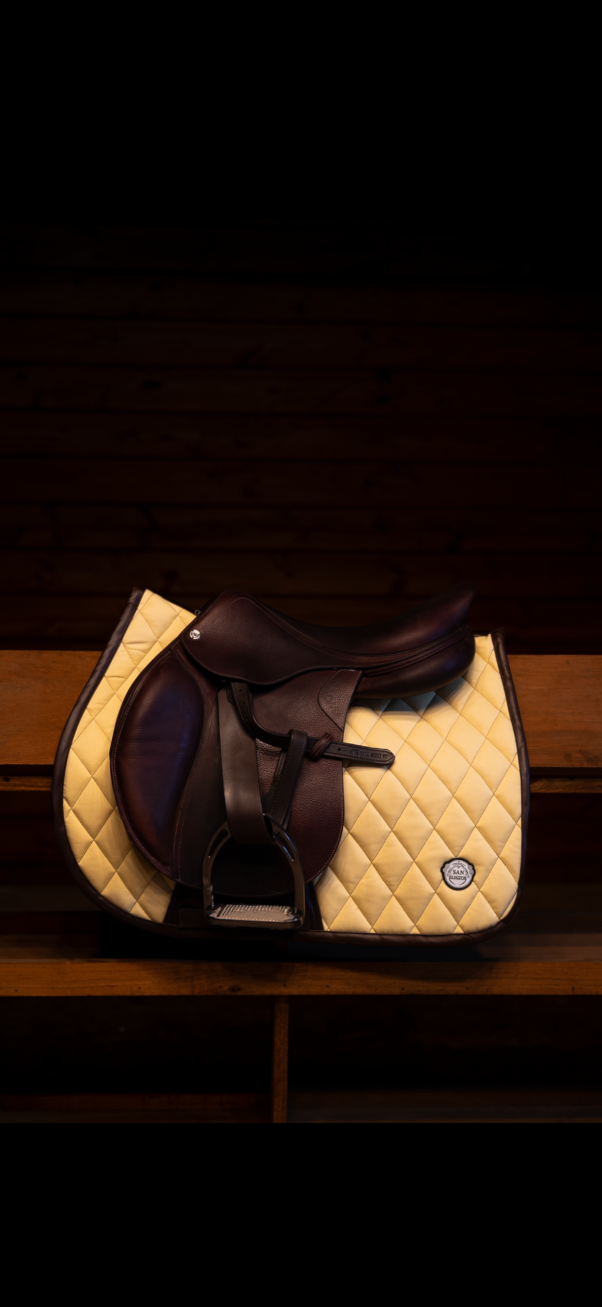 San Eligius yellow quilted jump saddle pad with brown leather piping on horse under saddle