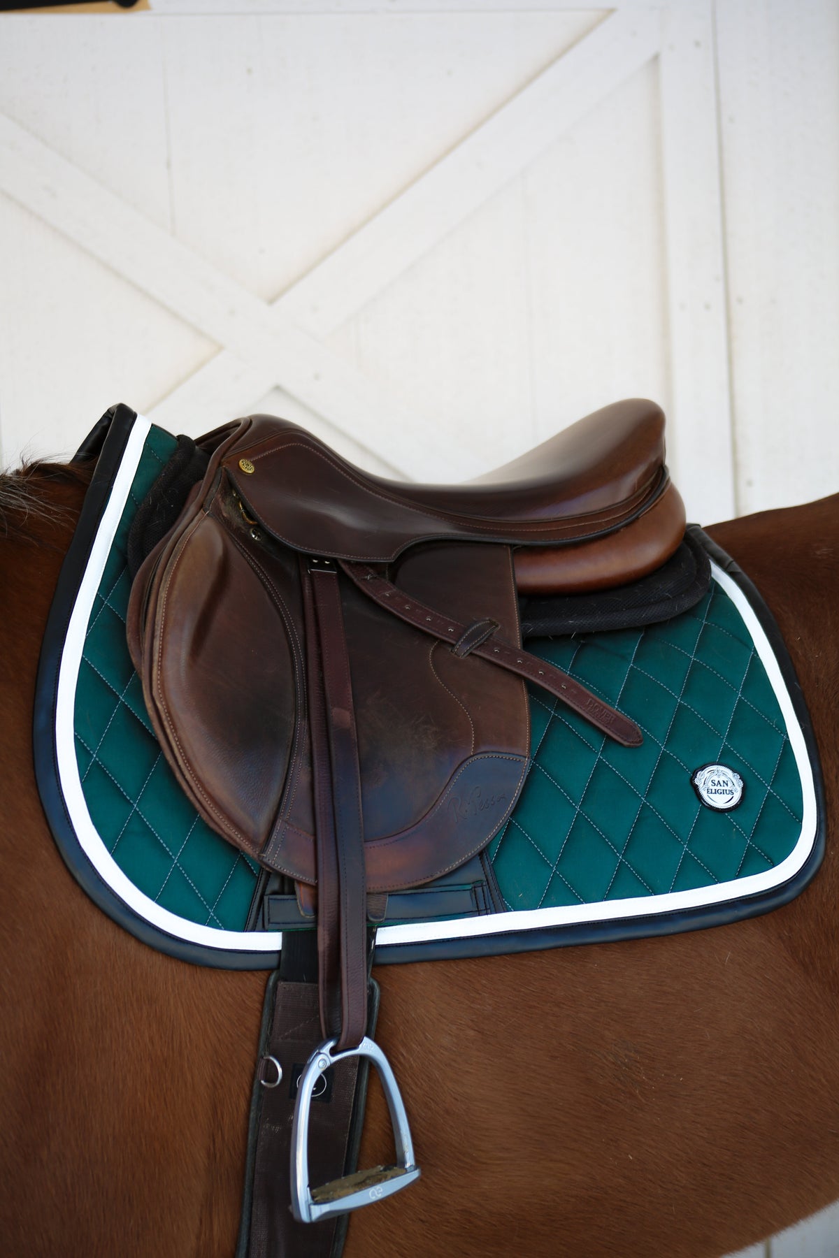 San Eligius green quilted jump saddle pad with white and black leather piping