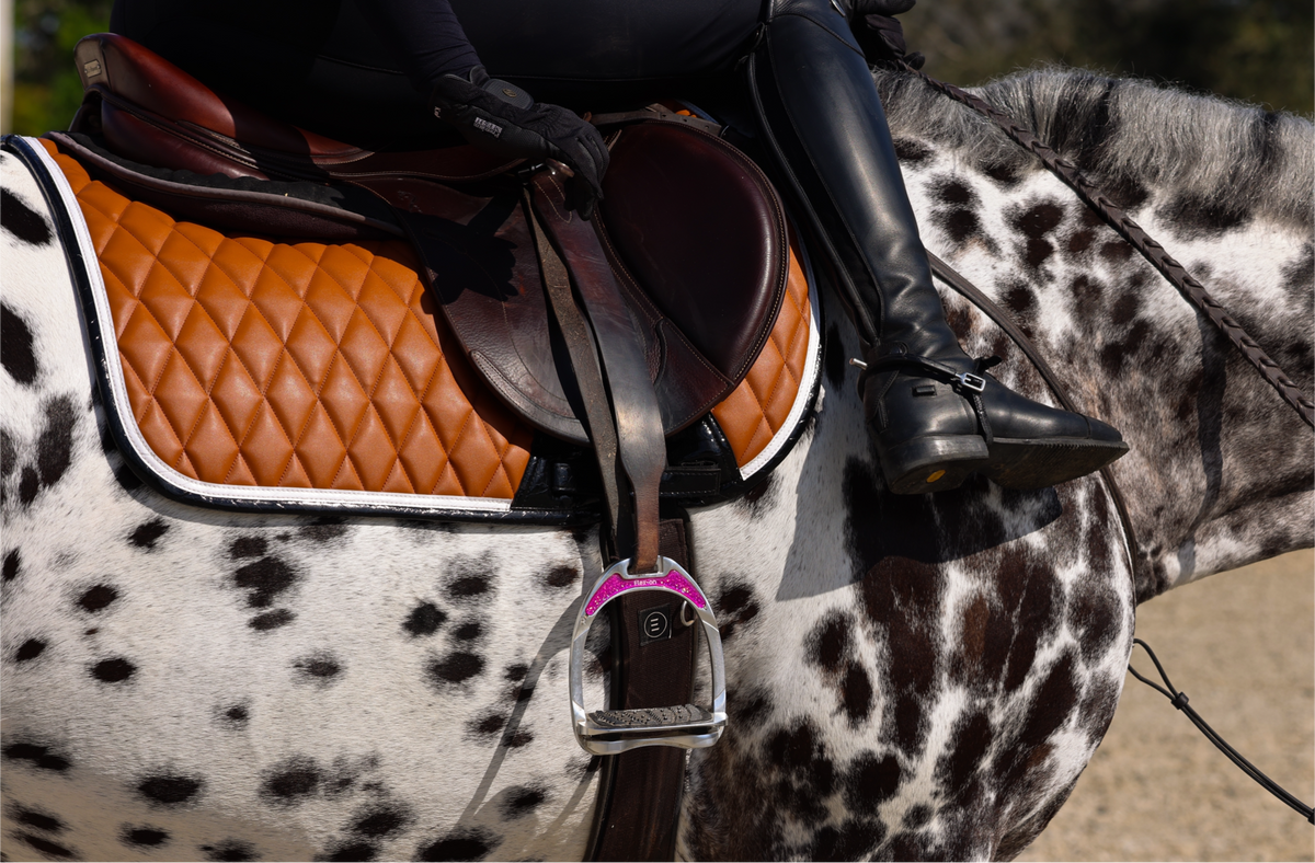San Eligius cognac quilted jump saddle pad with white and black crocodile piping, flat lay front view