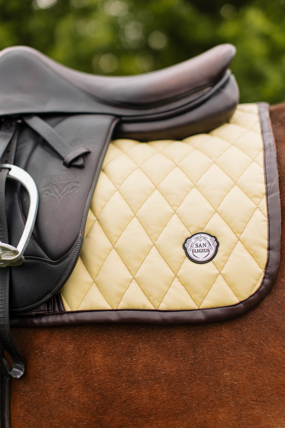 San Eligius yellow quilted jump saddle pad with brown leather piping