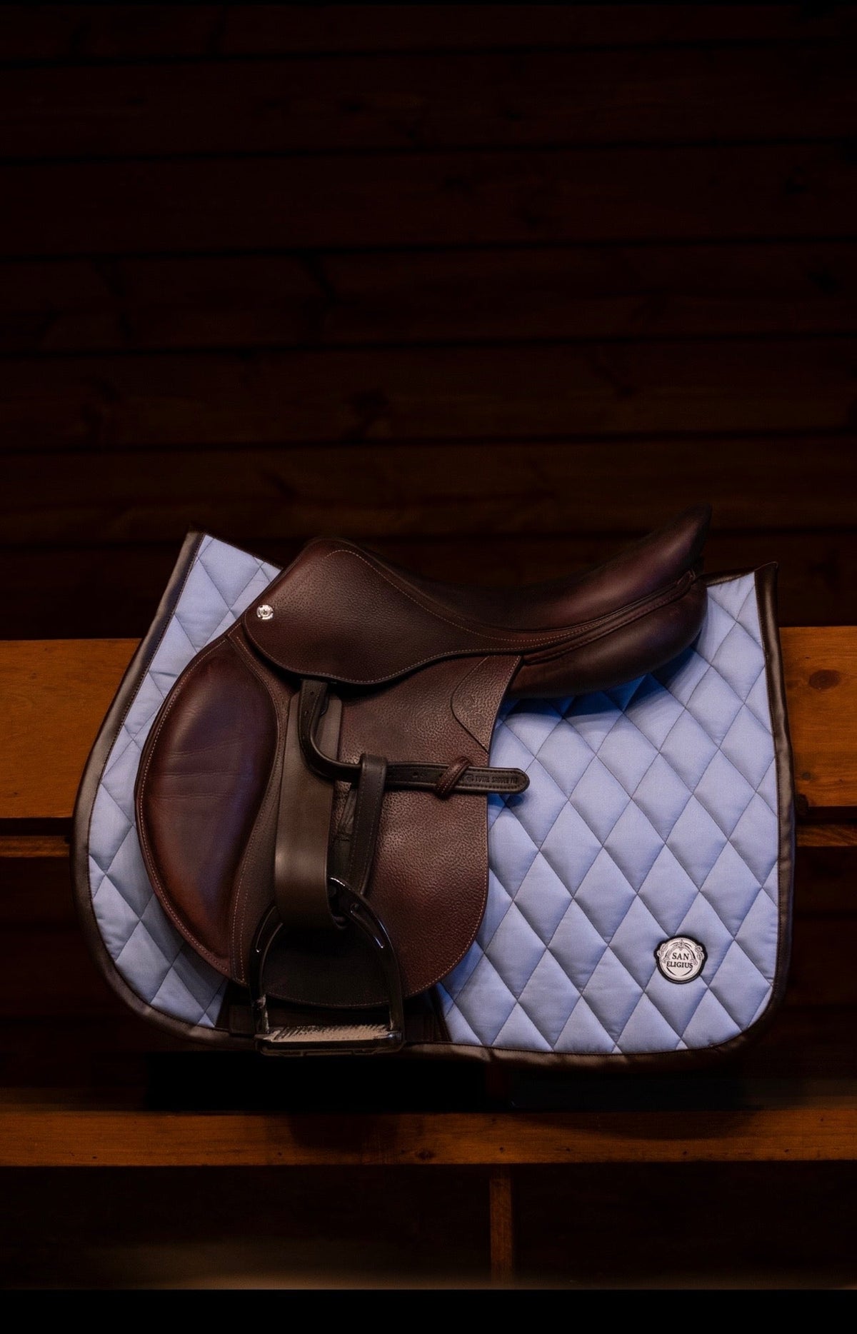 San Eligius light blue quilted jump saddle pad with brown leather piping