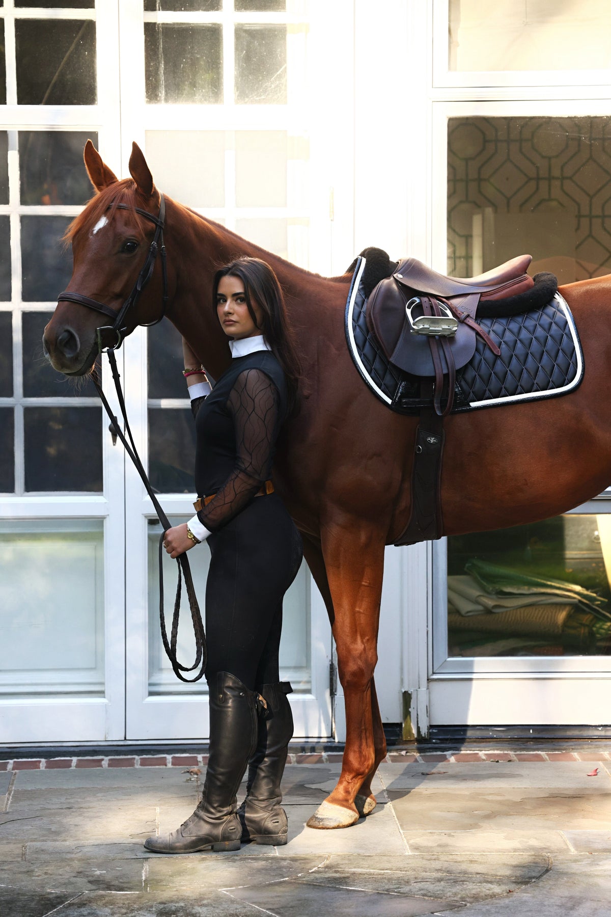 San Eligius black quilted jump saddle pad with white and black crocodile piping, back view