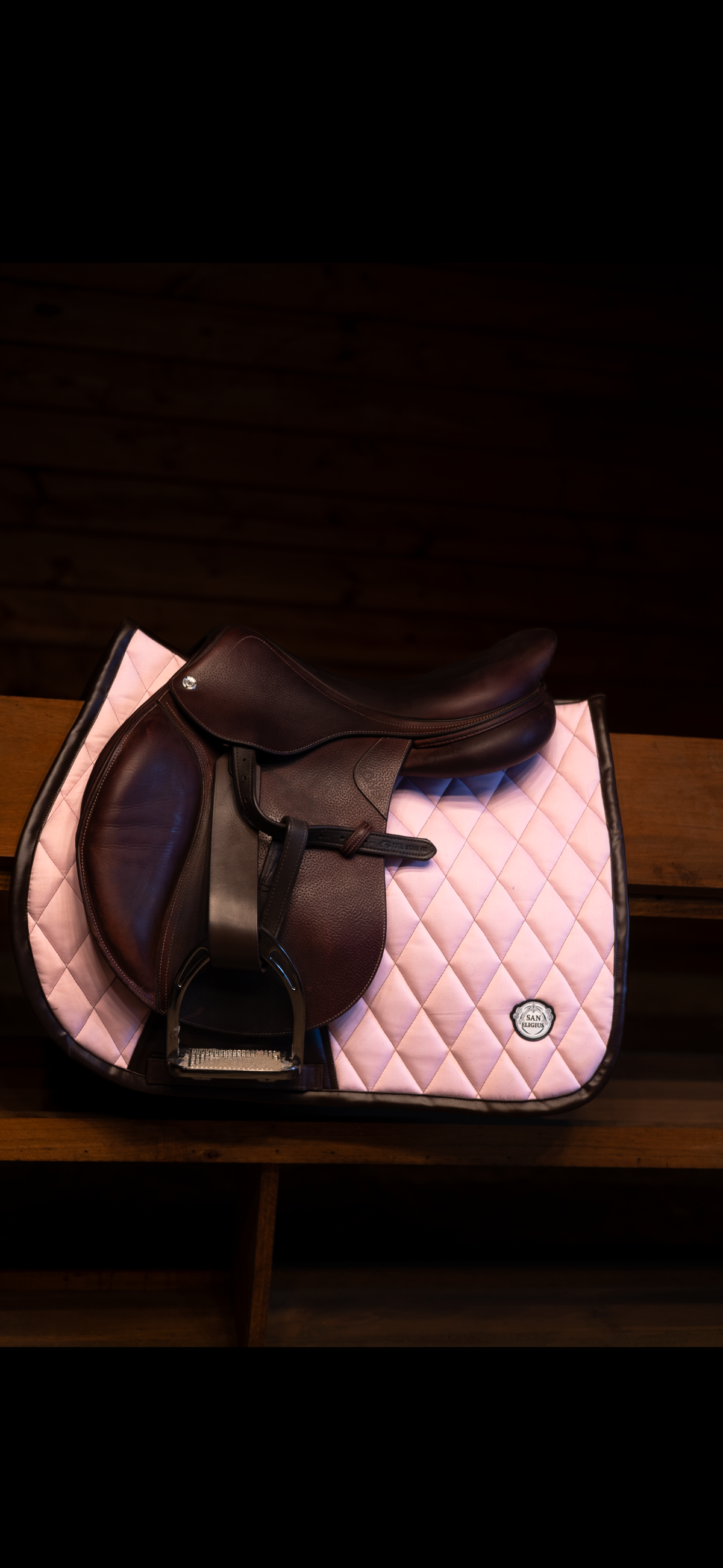 San Eligius pink quilted jump saddle pad with brown leather piping, flat lay front view