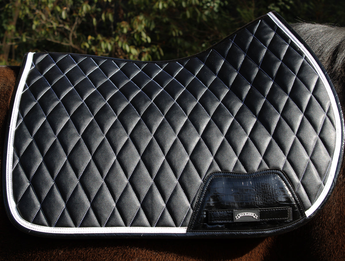 San Eligius black quilted jump saddle pad with white and black crocodile piping, close-up of piping detail