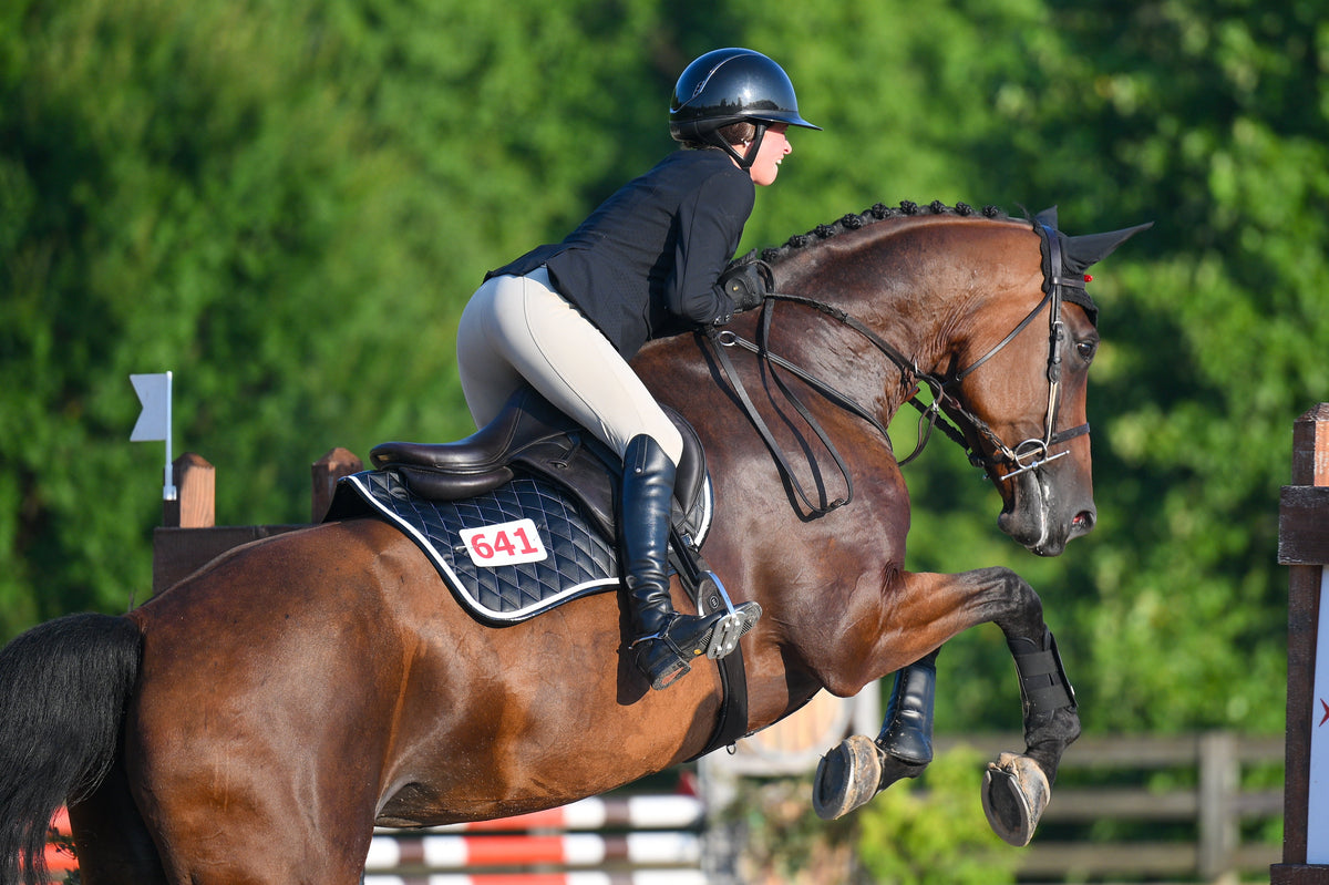 San Eligius black quilted jump saddle pad with white and black crocodile piping, detail of logo emblem