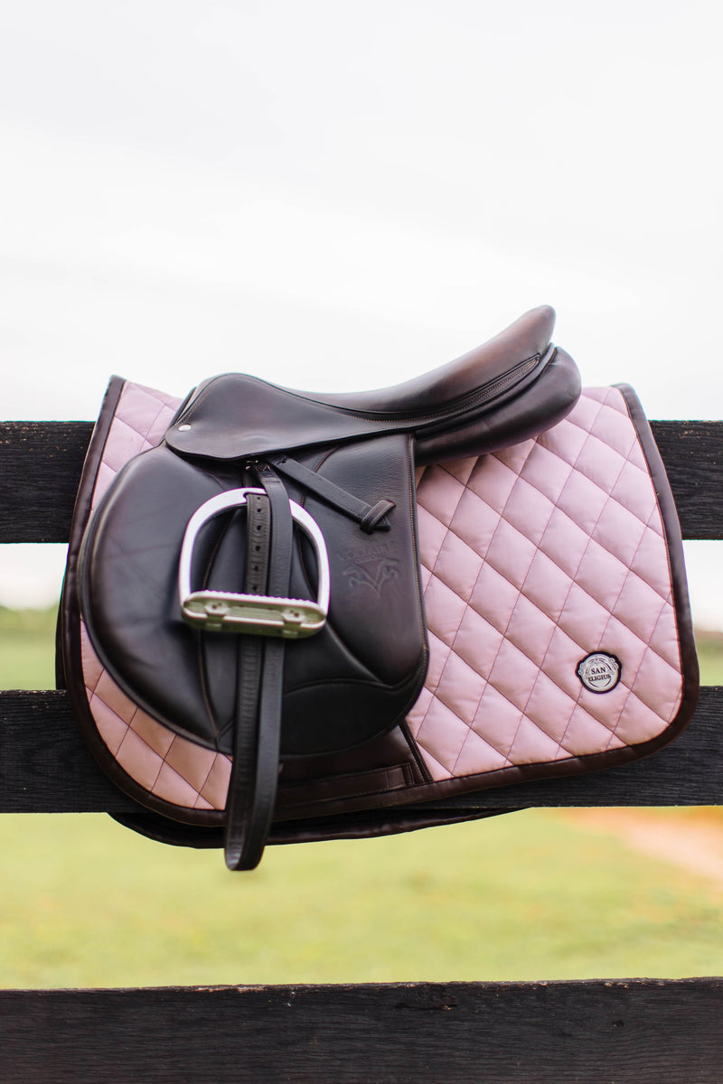 San Eligius pink quilted jump saddle pad with brown leather piping