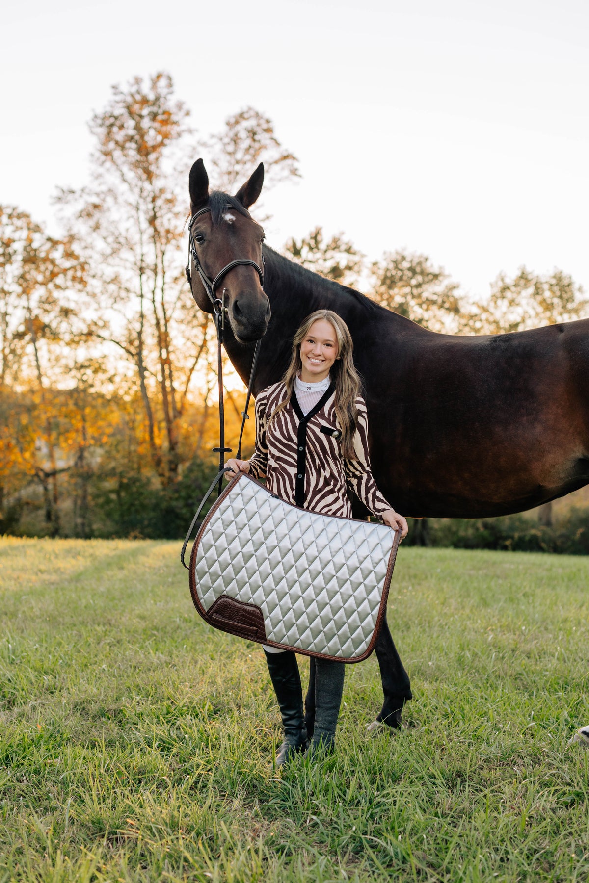 San Eligius chrome quilted jump saddle pad with brown crocodile piping, three-quarter view