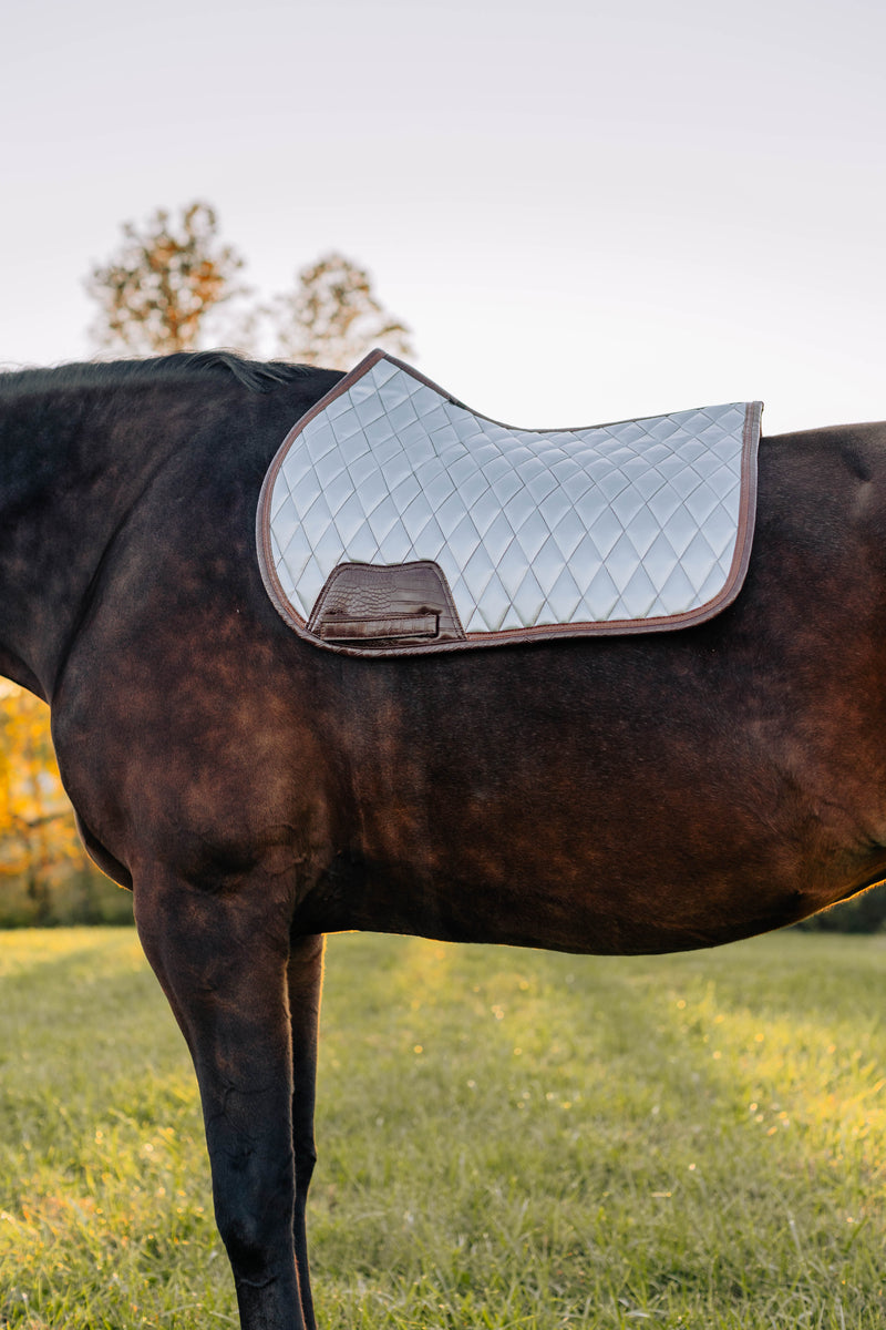 San Eligius chrome quilted jump saddle pad with brown crocodile piping